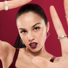 a woman making the peace sign with her hand