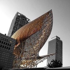 an artistic sculpture in front of some tall buildings