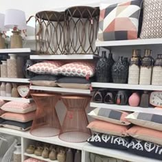 the shelves are filled with many different types of pillows and other decorative items on them