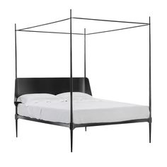 a bed with a black frame and white sheets