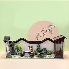 a miniature house with trees and plants in it