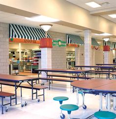 an empty cafeteria with tables and stools