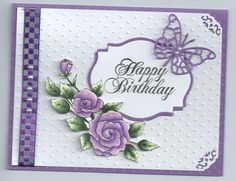 a birthday card with purple flowers and a butterfly on the top, in front of a white background