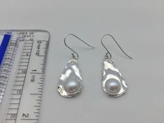 Hi everyone, just wanted to let you know we are open and shipping daily. Beautifully crafted handmade pearl and sterling silver dangle earrings. Features perfectly matched hand picked South Sea Pearls in a stunning silver setting so unique you will not go unnoticed. This line of pearl jewelry makes excellent brides made gifts and has been a top seller in our San Francisco jewelry store for years. Sterling Silver Pear Shaped Pearl Earrings, Hypoallergenic Drop Pearl Earrings In Sterling Silver, Minimalist Silver Pear-shaped Pearl Earrings, Hypoallergenic Pear-shaped Sterling Silver Jewelry, Silver Teardrop Pearl Earrings With Ear Wire, Handmade Silver Pearl Earrings For Anniversary, Handmade Sterling Silver Pearl Earrings For Gift, Handmade Silver Pearl Earrings As Gift, Handmade Silver Pearl Earrings For Gift