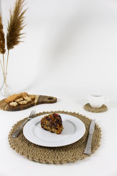 a piece of cake sitting on top of a white plate next to a fork and knife