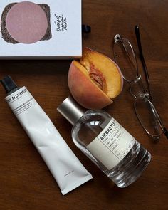 the contents of a personal care kit including an apple, eyeglasses and hand cream