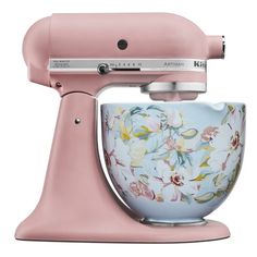 a pink mixer with flowers painted on it