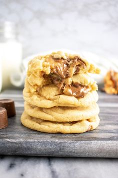 a stack of cookies sitting on top of a wooden cutting board