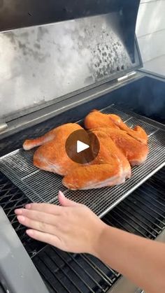 someone is cooking some chicken on the grill