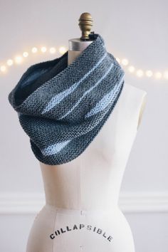 a mannequin wearing a blue and white striped scarf