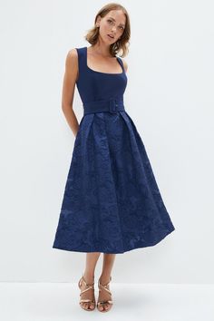 Contemporary femininity meets timeless elegance with this sharply-tailored midi dress. The square neckline complements a buckle belt detail, creating the effect of a cinched waist and balancing out the ensemble. Embroidered with floral patterns, the skirt gracefully falls down to a midi length. Pair with heels and minimal accessories for the perfect final touches.Expertly designed for those 5'3" and under, our Petite pieces are perfectly proportioned for a smaller frame using shorter lengths.Style: A-Line DressDesign: PlainFabric: Fancy FabricLength: MidiNeckline: SquareSleeve Length: Sleeveless Formal Balance Dress, Winter Dress Wedding Guest, Petite Dresses Wedding Guest, Moh Dress, Winter Wedding Guest Dresses, Wedding Guess Dress, Simple Frock, Winter Wedding Guest, Navy Blue Cocktail Dress