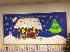 a bulletin board decorated with christmas decorations and a gingerbread house on the front wall