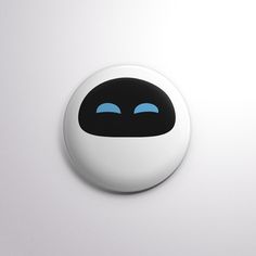 a black and white button with blue eyes