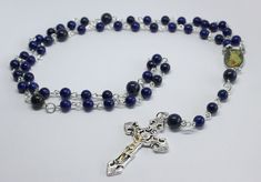 A beautiful five decade rosary made using 6mm and 8mm lapis lazuli gemstone beads. The crucifix measures approximately 5cm by 3cm. Wrapped in tissue paper and presented in an organza gift pouch. Elegant Silver Beads Rosary Gift, Gift Rosary With Silver Round Beads, Silver Beads Rosary As Gift, Elegant Beaded Rosary With Round Beads, Silver Beaded Rosary As Gift, Elegant Beaded Rosary For Gift, Elegant Beaded Rosary As Gift, Elegant Beaded Rosary, Elegant Rosary With Polished Beads As Gift