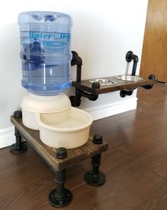 a water dispenser sitting on top of a wooden table