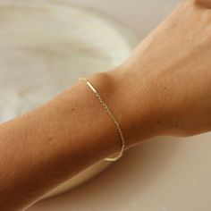 Our Sailor Bracelet is one of our fan favorites! As a best selling chain, the Sailor Bracelet is known for its perfectly dainty bar and link chain. The understated elegance of this bracelet leaves your stacking options endless! DETAILS 14k Gold Fill or Sterling SilverBracelet Sizing: XS=5.5", S=6", M=6.5", L=7", XL=7.5" To measure your wrist size, wrap a piece of string around your wrist the way you would like the bracelet to fit. Then lay the string flat and measure the inches to get your size. Elegant Hypoallergenic Chain Bracelet For Everyday, Everyday 14k Gold Satellite Chain Bracelet, Classic Gold Bracelet With Satellite Chain, Classic Delicate Chain Bracelet, Minimalist Gold Bracelet With Figaro Chain As Gift, Minimalist Gold Bracelet With Satellite Chain, Minimalist Gold Bracelet With Figaro Chain, Minimalist Everyday Gold Bracelet With Delicate Chain, Everyday Minimalist Gold Bracelet With Delicate Chain