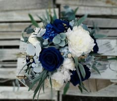 a bridal bouquet with blue and white flowers