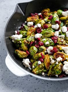 brussel sprouts with cranberries and feta cheese in a skillet