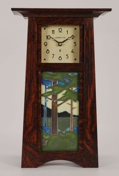 a wooden clock with stained glass on the front and sides, inlaid to trees