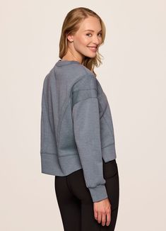 Our In The Studio Cropped Pullover combines a classic crewneck design and super soft, trendy scuba fabric for a lightweight pullover you can take from studio to street. A slightly cropped length is complemented by a relaxed fit, dropped shoulders and sporty seaming detail that allow for easy styling and layering. Throw this cute crop sweatshirt over a sports bra for a workout or pair it with jeans for a casual-cute look. Versatile Crew Neck Tops With Ribbed Cuffs, Relaxed Fit Cropped Sweater For Layering, Crew Neck Relaxed Fit Cropped Sweater In Athleisure Style, Oversized Sporty Cropped Sweater With Crew Neck, Casual Crew Neck Cropped Sweater For Layering, Athleisure Relaxed Fit Crew Neck Cropped Sweater, Sporty Oversized Cropped Sweater With Crew Neck, Versatile Long Sleeve Sweatshirt With Ribbed Cuffs, Sporty Crew Neck Sweatshirt For Layering