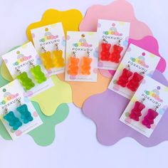 small gummy bear ear clips in assorted colors on colorful paper with polka dots