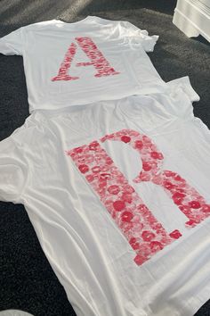 two t - shirts that have been made to look like letters and flowers on them