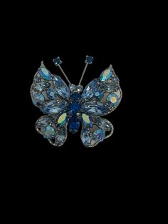 Add a touch of elegance to your outfit with this stunning Regency signed brooch. Featuring a beautiful butterfly design with light and dark blue crystal rhinestones, this vintage piece is sure to turn heads. The prong set marquise and round brilliant stones are set in silver tone metal, giving the brooch a timeless appeal. This handmade brooch is a one-of-a-kind piece and is perfect for any fashion-forward individual. The Regency brand is known for its high-quality jewelry, making this brooch a Evening Butterfly Brooch, Elegant Blue Butterfly Brooches, Butterfly Light, Butterfly Lighting, Brooch Vintage, Light And Dark, Brooches Handmade, Vintage Butterfly, Blue Rhinestones