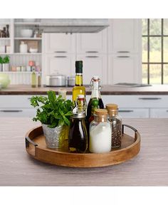 an assortment of condiments are arranged on a tray in the middle of a kitchen