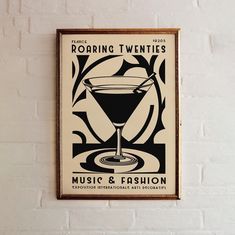 an old fashion poster hangs on the wall next to a white brick wall with a black and white design