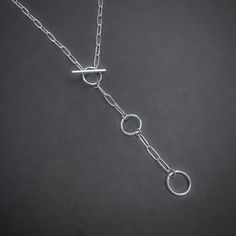 Elevate your everyday look with this handcrafted Paperclip Chain Toggle Necklace. The unique toggle clasp adds a touch of modern charm, while the adjustable length allows for versatile styling options. Made from high-quality sterling silver, this necklace is the perfect addition to your jewelry collection. Details: Chain: Solid Sterling Silver Paperclip Chain, 3mm Clasp: Handcrafted Sterling Silver toggle clasp, adjustable length Sizes: 16 inches to 24 inches Shipping: Ready to ship within one b Gemstone Pendants, Toggle Necklace, Jewelry Gemstone, Lariat Necklace, Toggle Clasp, Pitcairn Islands, Guinea Bissau, Mozambique, Paper Clip