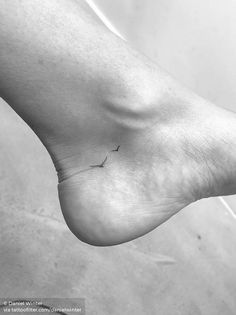 a black and white photo of a person's foot