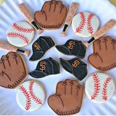 decorated cookies with baseball and mitts on a plate