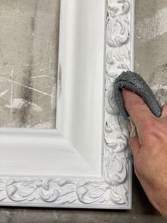 a person is cleaning the frame with a sponge