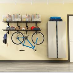 there is a bike that is hanging on the wall next to some shelves with items