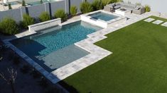 an aerial view of a backyard with a swimming pool