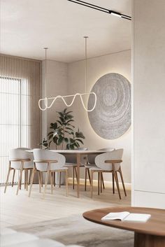 a dining room with white chairs and a round table