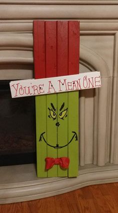 a wooden sign that says you're a mean one with a red bow tie