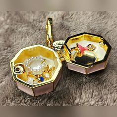 **Rare Juicy Couture Limited Edition 2014 Ballerina Pink Music Jewelry Box Locket Charm** This Rare, Limited Edition 2014 Juicy Couture Ballerina Pink Music Jewelry Box Locket Charm Is A True Collector's Item, Perfect For Adding A Touch Of Elegance And Whimsy To Your Jewelry Collection. Adorned With Glitter Accents And A Gold Crown On Top, This Locket Captures The Essence Of Juicy Couture's Playful Yet Luxurious Style. **Features:** - **Design:** Pink Music Jewelry Box With Glitter Accents And A Ballerina Jewelry Box Music, Juicy Charms, Music Jewelry Box, Pink Music, Ballerina Pink, Music Box Jewelry, Music Jewelry, Juicy Couture Jewelry, Magical Jewelry