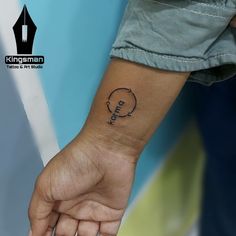 a person's wrist with a small tattoo on it