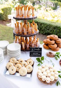 a table topped with lots of donuts and desserts