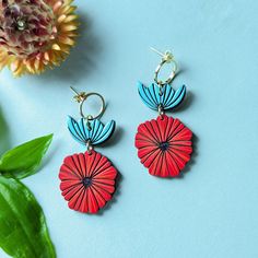 These abstract Scandinavian poppy flower earrings are a vibrant and modern set that make a perfect gift or statement for yourself! These original earrings are hand painted on cherry wood and feature abstract red poppies, tulips, and 18k gold-plated circle studs for a geometric and modern look. If you love scandi, mid-century modern, or abstract art, these are for you! These earrings feature 12mm circular 18k gold plated brass studs with butterfly backs. The fronts are finished with a satin varni Red Hand-painted Flower Earrings For Gifts, Artsy Red Earrings As A Gift, Vibrant Red Earrings For Gift, Vibrant Red Drop Earrings, Mid Century Earrings, Wood Earrings Stud, Painted Jewelry, Poppy Flowers, Hand Painted Jewelry