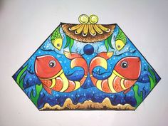 this is an image of a colorful fish design on a white wall with blue and yellow colors