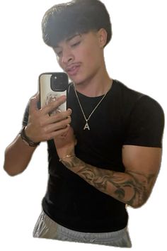 a man with tattoos is taking a selfie in front of his cell phone while wearing a black t - shirt