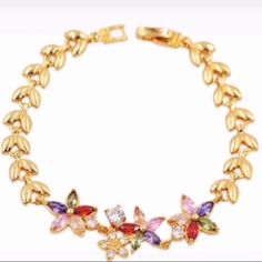 This Gold Plated Multi Color Crystal Bracelet Elegant Flower Crystal Bracelet For Spring, Elegant Flower Shaped Crystal Bracelet For Spring, Elegant Multicolor Bracelets For Spring, Tiffany And Co Bracelet, Howlite Bracelet, Lava Stone Bracelet, Faux Pearl Bracelet, Hematite Bracelet, Color Flower