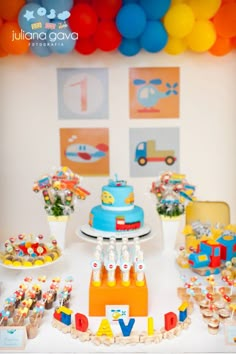 a table topped with lots of cakes and desserts