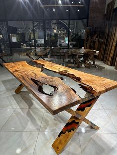 the table is made out of wood and has an unusual design on it's legs