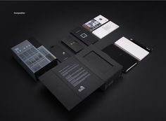 an assortment of business cards and stationery on a black surface with the same design