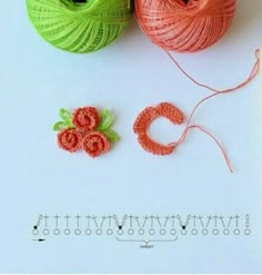 two balls of yarn sitting next to each other on top of a white surface with crochet