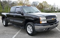 a black pickup truck parked in a parking lot