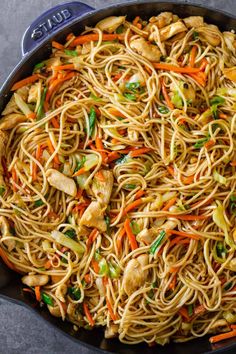 a skillet filled with noodles and vegetables